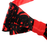 Black ink on a red bow tie.