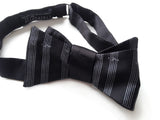 Sheet music bow tie: dove grey on black.