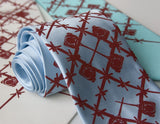 Crimson ink on sky blue, cream, aqua.