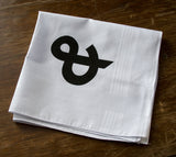 Black ink on white cotton handkerchief.