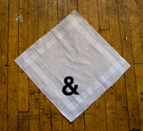  Black ink on white cotton handkerchief.