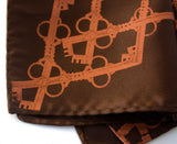 Copper ink on dark brown pocket square.