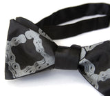 Dove grey ink on a black bow tie.