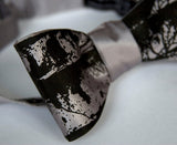 Black ink on silver bow tie.