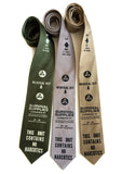 Civil Defense necktie: ivory-cream on olive; black on silver; black on champagne.