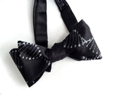 DNA bow tie: Silver print on black.