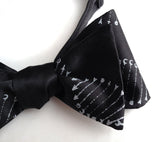 DNA bow tie: Silver print on black.