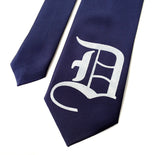 Old English D necktie: white on navy tie.