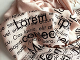 Lorem Ipsum Scarf: Black on blush.