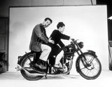 Charles and Ray Eames pose on a Velocette motorcycle, 1948. ©Eames Office, LLC