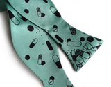 Pill Spill bow tie: Black on mint.