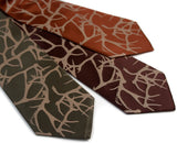 Silk Antler print neckties. Tan on champagne, dark brown, cinnamon.