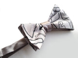  Black pearl ink on a silver bow tie.